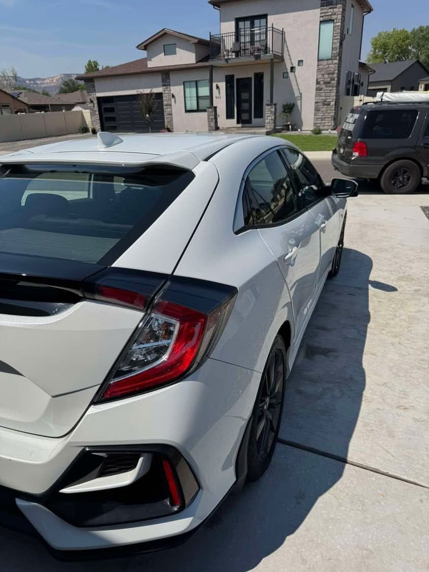 White Honda Civic hatchback, washed and shining in a driveway